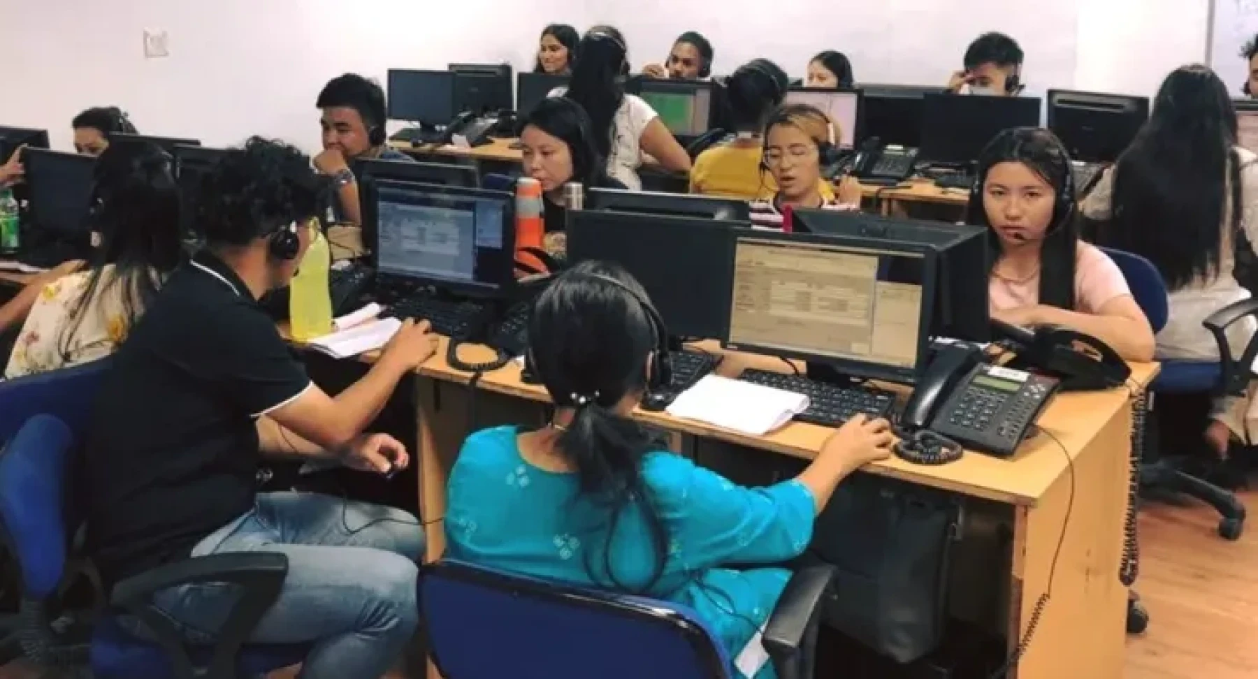 RHI call centre floor with agents using computers, telephones and headsets.